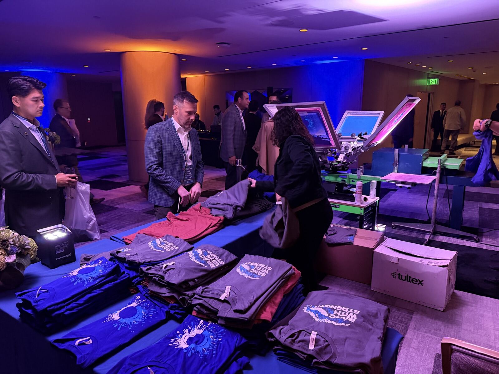 Merch Troop crew running a live heat press production line